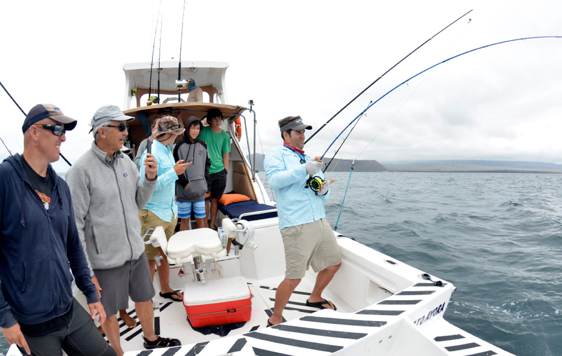 Passengers fishing onboard a boat charter